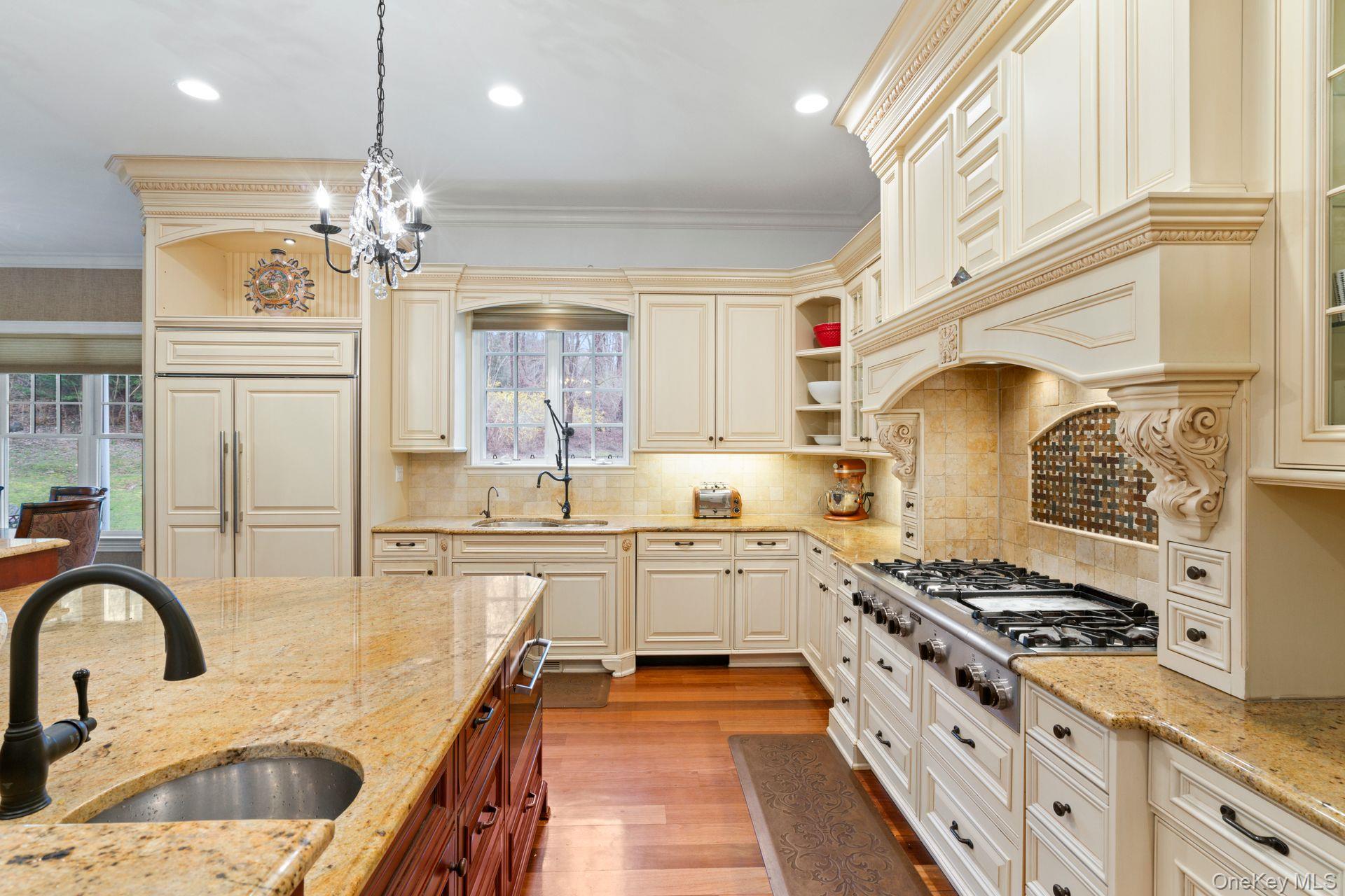 280 Southdown Road Lloyd Harbor, NY 11743 - Photo 14 of 39 a kitchen with stainless steel appliances a stove a sink dishwasher and white cabinets with wooden floor