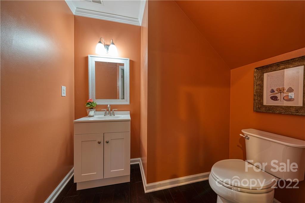 2086 Calloway Pines Drive Tega Cay, SC 29708 - Photo 19 of 47 a bathroom with a toilet a sink a vanity and mirror
