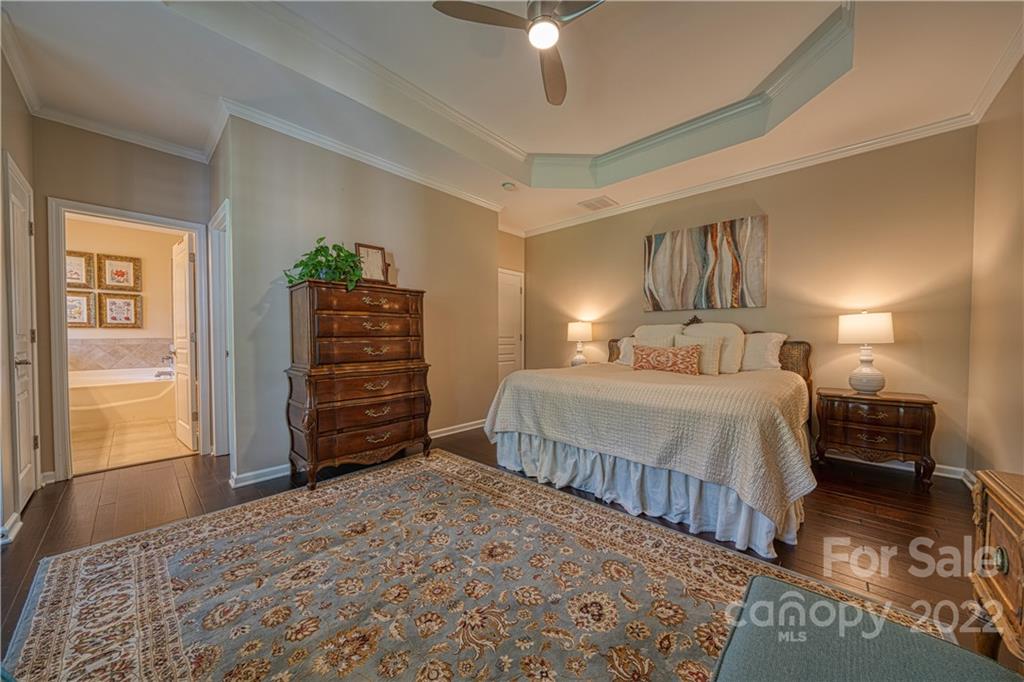 2086 Calloway Pines Drive Tega Cay, SC 29708 - Photo 25 of 47 a bedroom with a bed and a chandelier