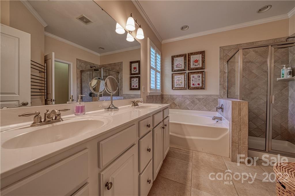 2086 Calloway Pines Drive Tega Cay, SC 29708 - Photo 28 of 47 a bathroom with a tub a sink and mirror