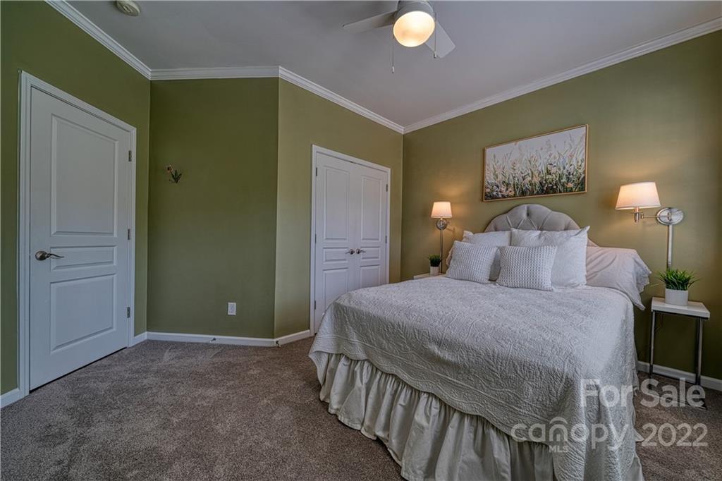 2086 Calloway Pines Drive Tega Cay, SC 29708 - Photo 36 of 47 a bedroom with a bed and a chandelier