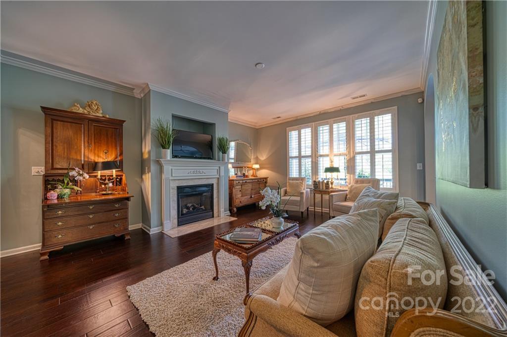 2086 Calloway Pines Drive Tega Cay, SC 29708 - Photo 7 of 47 a living room with furniture a fireplace a flat screen tv and a large window