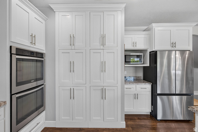 1263 East 1200th South Springville, UT 84663 - Photo 12 of 60 Kitchen featuring white shaker-style cabinetry, stainless steel double wall ovens, built-in microwave, a stainless steel refrigerator, and granite countertops