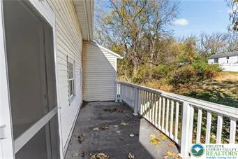 a view of a balcony with wooden floor and fence