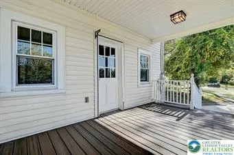a view of backyard with deck and wooden floor