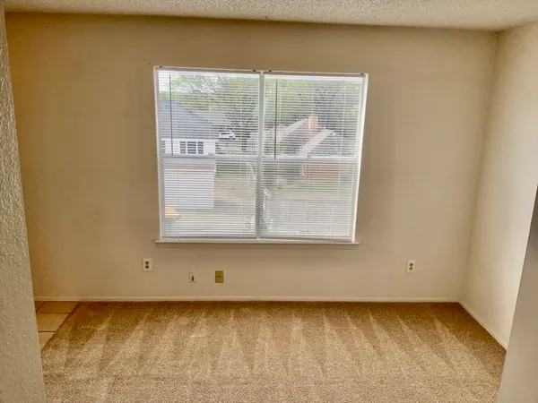a view of a small space with wooden floor and a window