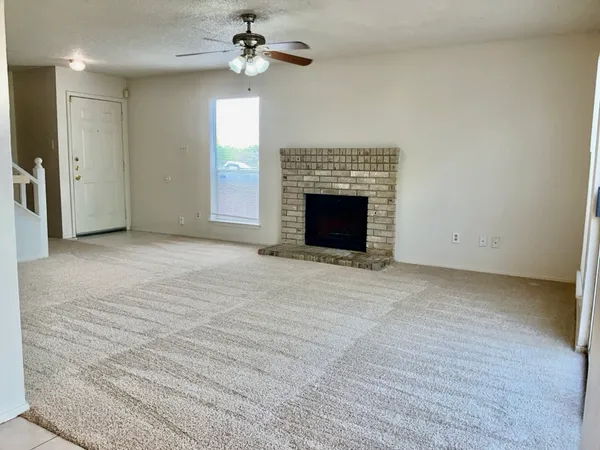 a view of empty room with a fireplace