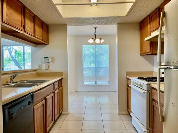 a kitchen that has a sink a stove and a microwave