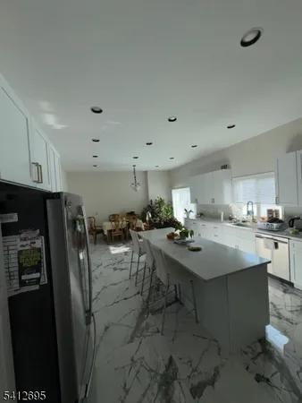 a room with stainless steel appliances lots of counter space and breakfast area