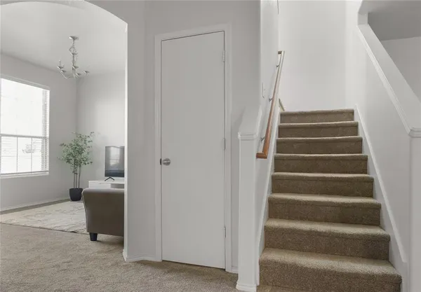 a view of an entryway with wooden floor and a living room
