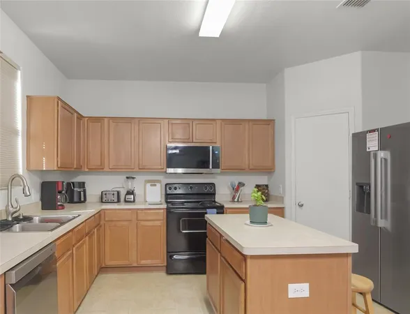 a kitchen with a sink a stove and refrigerator