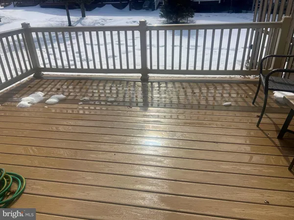 a deck with chair and table with wooden floor