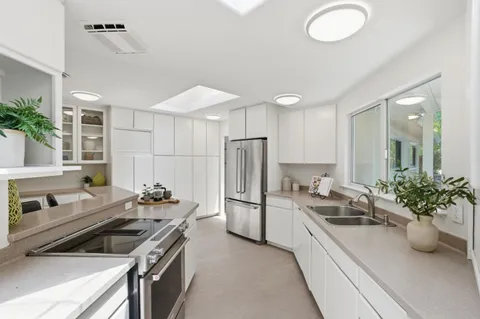 a kitchen that has a sink and a stove