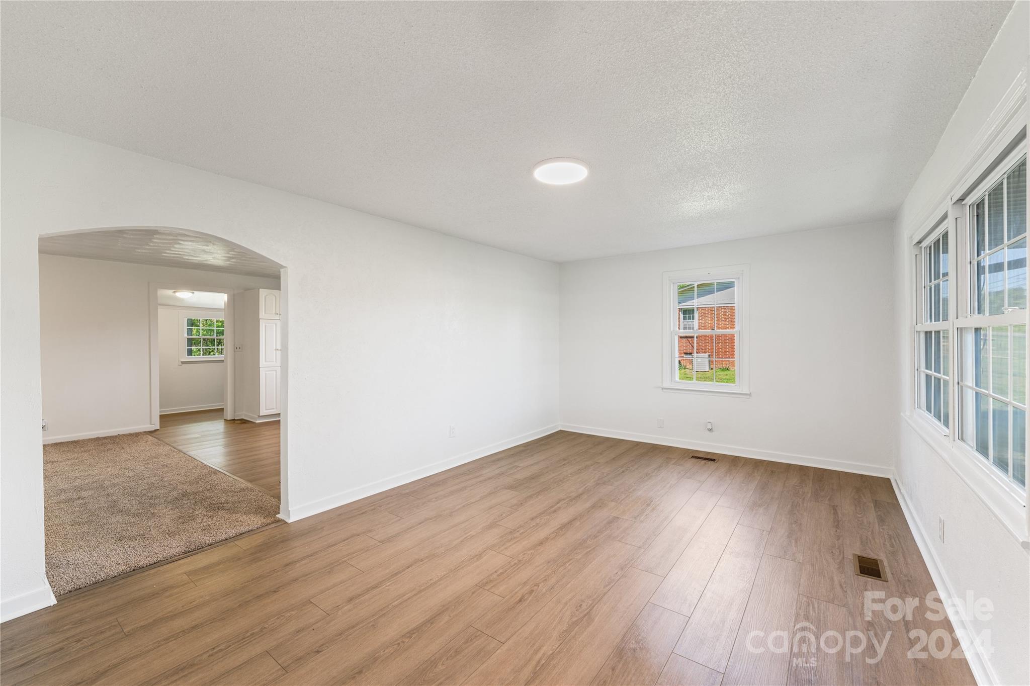 875 Marys Grove Road Cherryville, NC 28021 - Photo 21 of 28 an empty room with wooden floor and windows