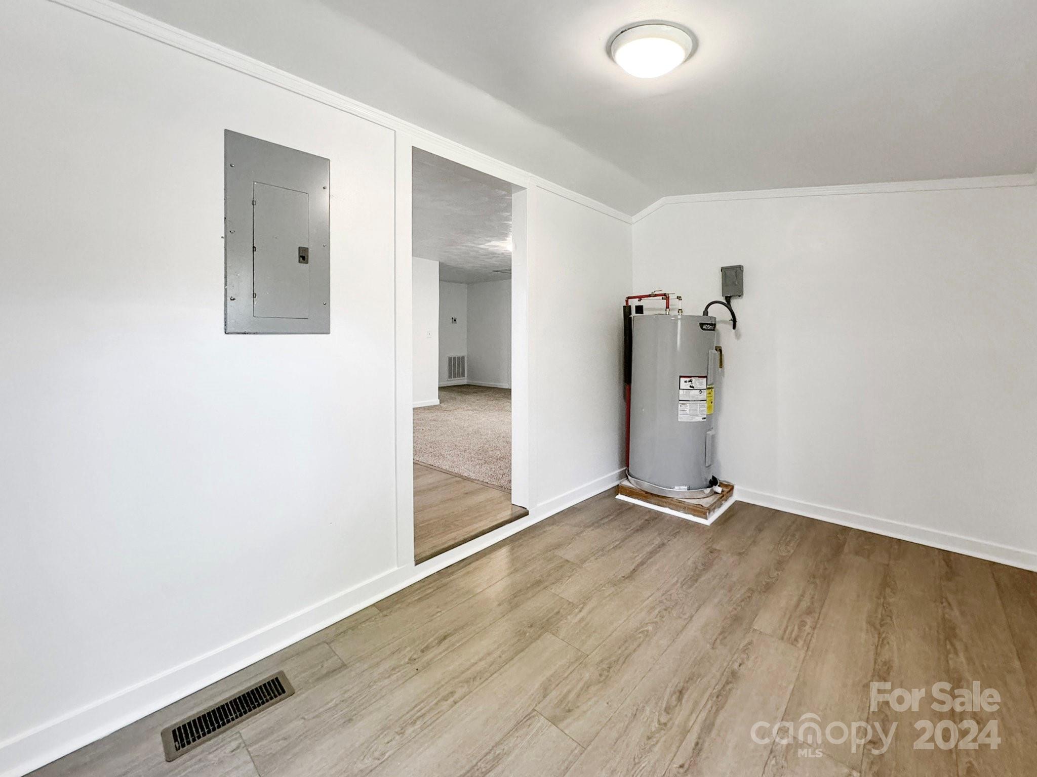 875 Marys Grove Road Cherryville, NC 28021 - Photo 10 of 28 an empty room with wooden floor and a bathroom