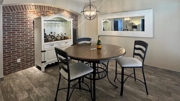 a view of a dining room with furniture and chandelier