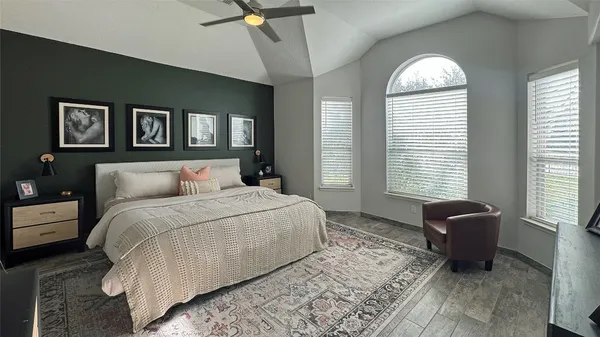 a bedroom with a bed and glass window