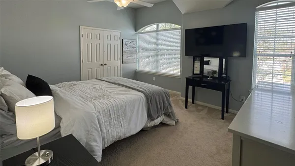 a bed room with a bed window and a chair
