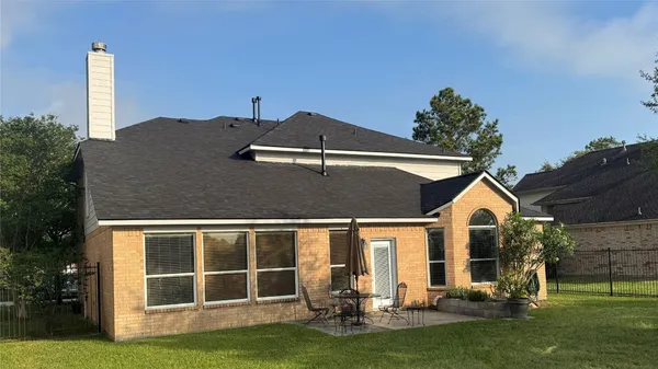 a front view of house with a garden and yard