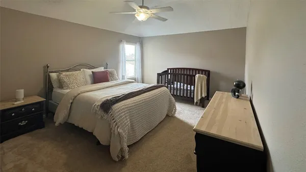 a spacious bedroom with two beds and a chandelier