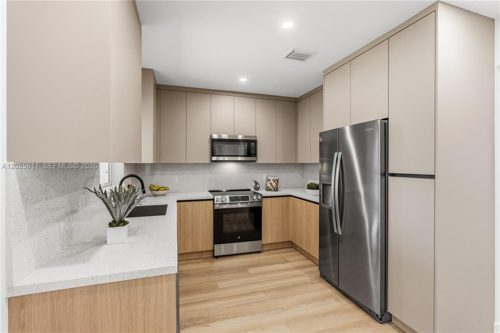 2110 Southwest 15th Street Miami, FL 33145 - Photo 10 of 37 a kitchen with stainless steel appliances granite countertop a refrigerator sink and stove