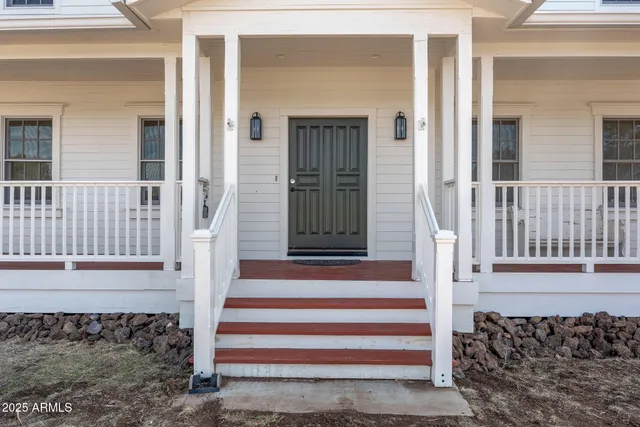 a living room with furniture a chandelier a rug and a window