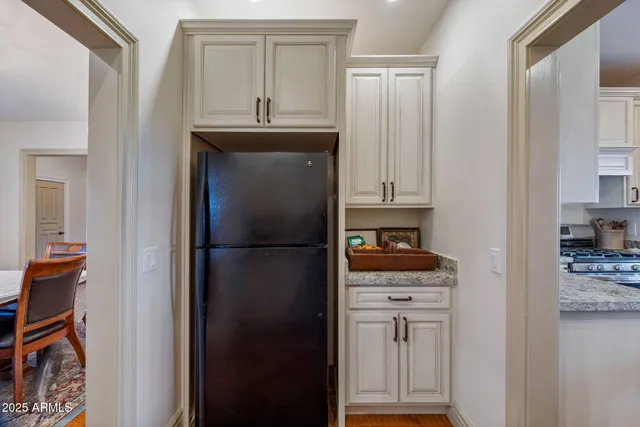 a view of staircase with lots of frames on wall and wooden floor