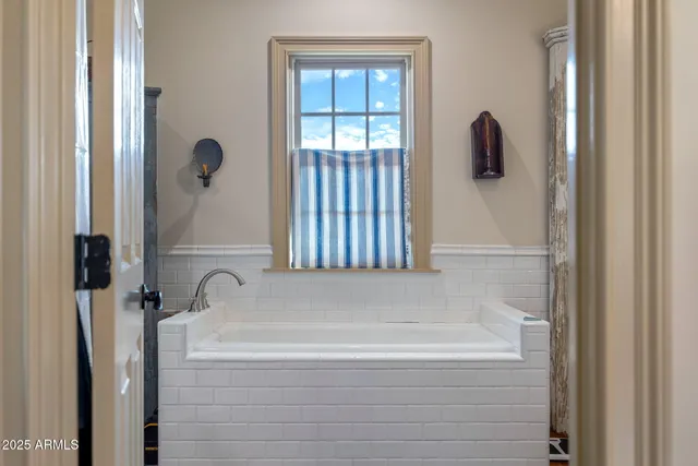 a bed room with a bed and a ceiling fan