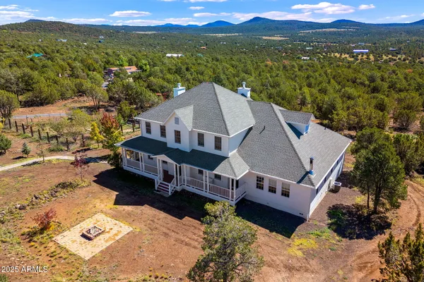 a living room with furniture and a book shelf