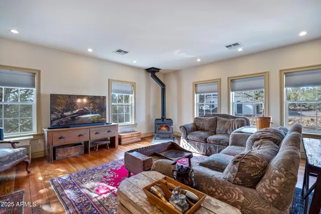 a bedroom with a bed and dresser with chair