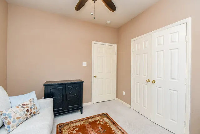 a living room with furniture and a baby crib