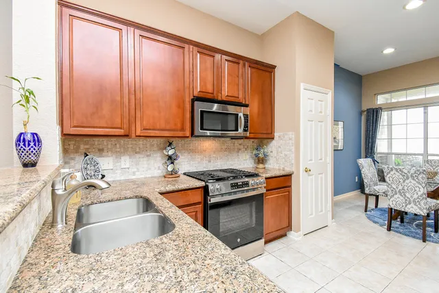 a kitchen with a stove a sink and a microwave