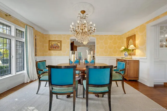 a view of a dining room with furniture and a chandelier