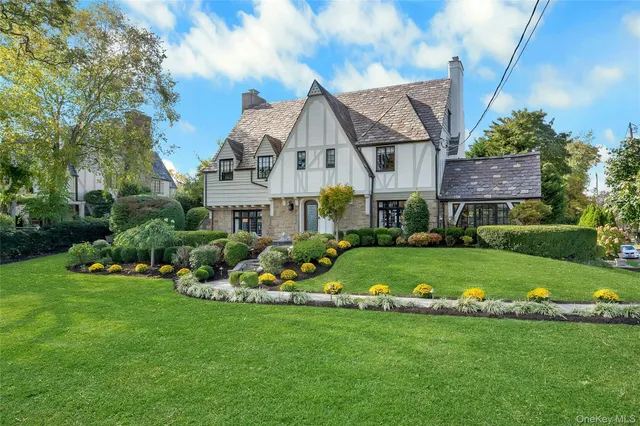 a front view of house with yard and green space
