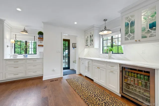 a kitchen with granite countertop a stove a sink and a refrigerator