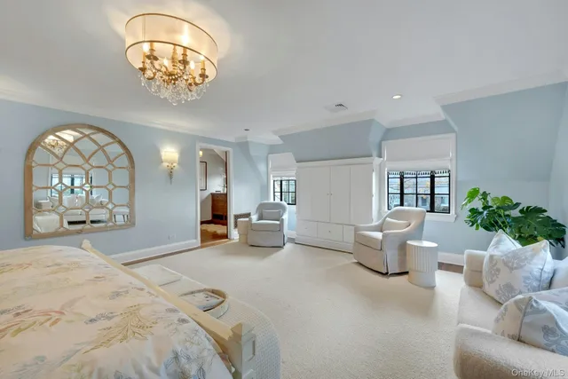 a bed room with furniture and a chandelier