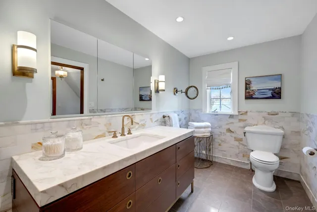 a bathroom with a sink double vanity and a toilet