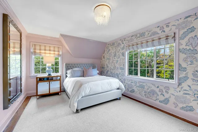 a bed sitting in a bedroom next to a window