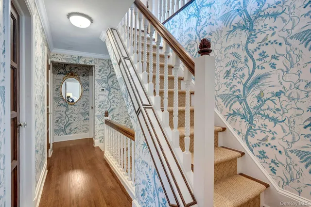 a view of a livingroom with furniture staircase and front door