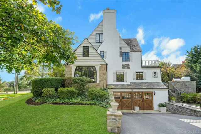 a view of a house with a big yard and large trees