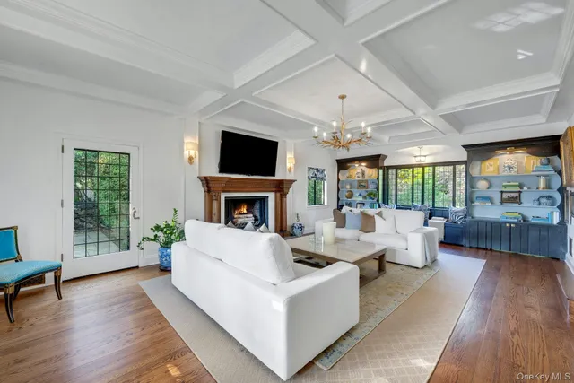 a living room with fireplace furniture and a flat screen tv