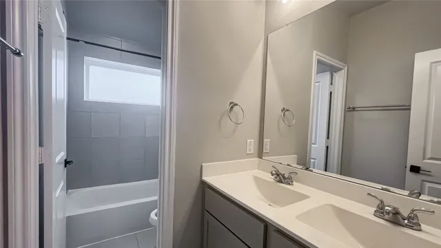 a bathroom with a tub sink and mirror