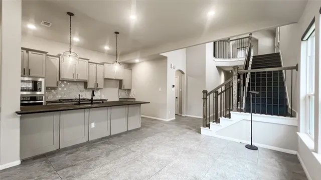 a large kitchen with a large window and stainless steel appliances