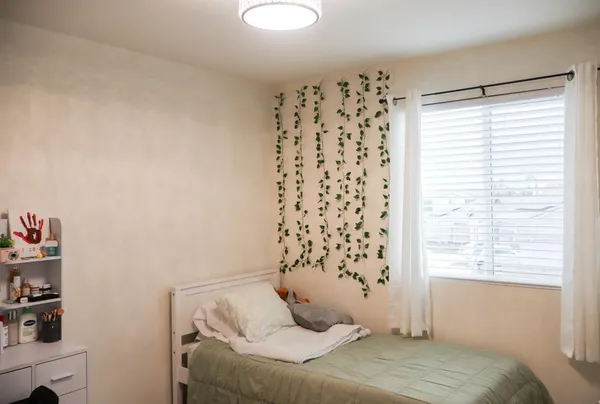 a bedroom with a bed and window