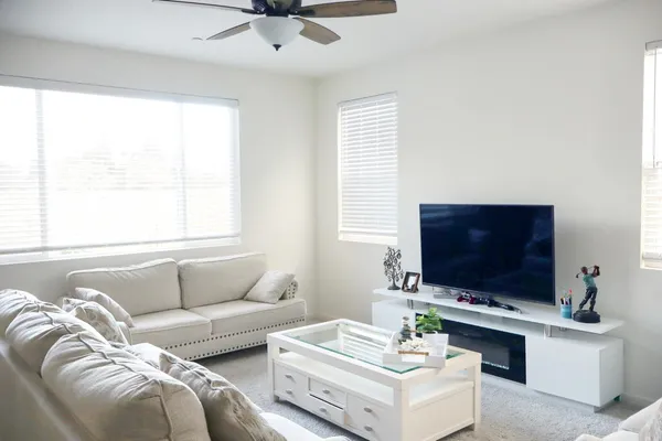 a kitchen with a dining table chairs sink and refrigerator