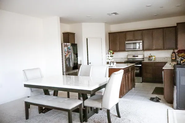 a backyard of a house with barbeque oven fire pit table and chairs