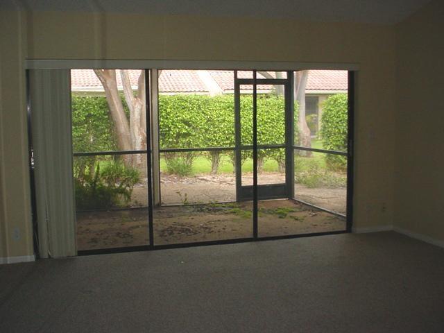 21601 Coronado Avenue Boca Raton, FL 33433 - Photo 3 of 10 a view of a room with a floor to ceiling window next to road