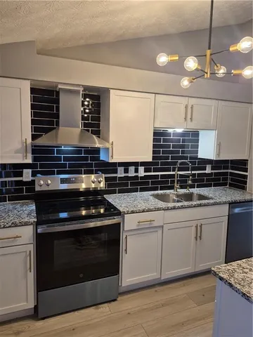 a kitchen with a stove and a sink