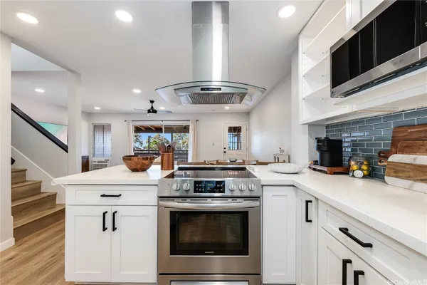 a kitchen with stainless steel appliances granite countertop a stove and a sink