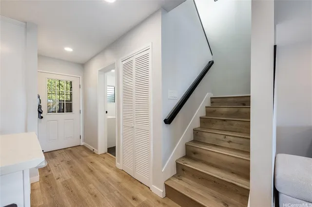 a view of entryway with wooden floor and stairs
